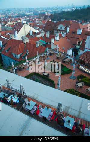 People dining on rooftop restaurant below Hrad the castle with views over Mala strana the little town historical quarter Prague Stock Photo