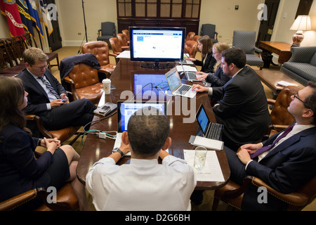 President Barack Obama participates in a live Twitter question and answer session in the Roosevelt Room of the White House. Stock Photo