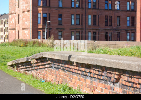 Tenement buildings next to abandoned railway line in Glasgow, Scotland Stock Photo