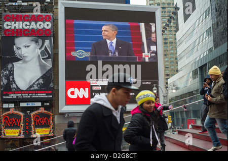 Passer-by gather in Times Square in New York on Monday, January 21, 2013 to watch the inauguration of Barack Obama Stock Photo