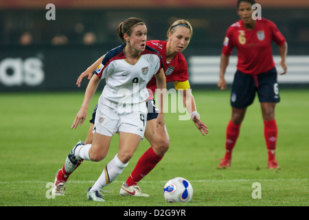 Heather O'Reilly of the USA (L) looks for space against Faye White of England (R) during a FIFA Women's World Cup match. Stock Photo