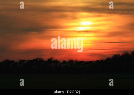 Red clouds, country, dark, dramatic, dusk, evening, exposure, field, hills, landscape, line, long, sun rays through red sky's. Stock Photo
