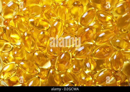 Closeup shot of fish oil pills in a white bowl on the white background ...