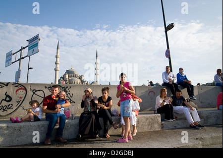 Istanbul: People enjoying an afternoon in the sun in Eminonu beside Galata Bridge. Stock Photo