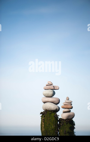 Stacks of stones on top of a wooden groyne on the beach at Porlock Weir, Somerset, England, United Kingdom Stock Photo