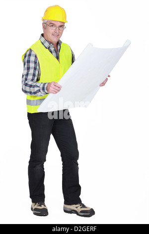 senior craftsman holding a blueprint Stock Photo