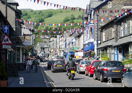 Street with traffic and stone buildings, Ambleside, Lake Windermere,  Cumbria, England, Britain Stock Photo