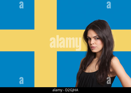 Portrait of young woman against Swedish flag Stock Photo