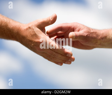 Two hands reaching out to each other Stock Photo