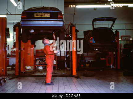 Garage & Mechanic Car On Inspection Ramp Stock Photo