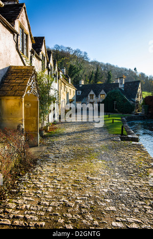 Cobblestones and cottages in Castle Combe Wiltshire England UK EU Stock Photo