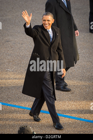 US President Barack Obama waves as he walks along Pennsylvania Avenue during the inaugural parade January 21, 2013 in Washington, DC. Obama was sworn-in as the nation's 44th President earlier in the day. Stock Photo