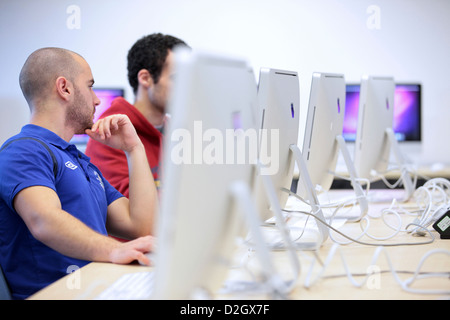 Two male students using iMac Apple computers. Computer/IT room in University, UK. Stock Photo