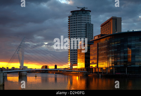 England, Greater Manchester, Salford quays, Setting sun reflected in Media city Stock Photo