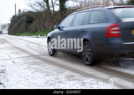 A Skoda Octavia estate car diving along a country road in Norfolk with a fresh layer of snow on it. The car is seen in motion. Stock Photo