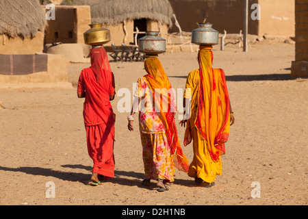 India, Rajasthan, Thar Desert, Three Indian women carrying water back to village Stock Photo