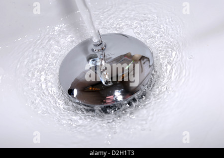 Water running down a bathroom sink plug hole