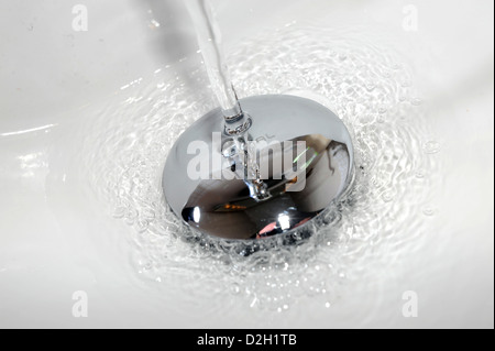 Water running down a bathroom sink plug hole