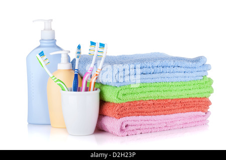 Toothbrushes, shampoo bottles and colored towels. Isolated on white background Stock Photo