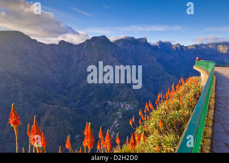 Tourist standing at the Eira do Serrado viewpoint overlooking the village of Curral Das Freiras or Valley of the Nuns Madeira Portugal EU Europe Stock Photo