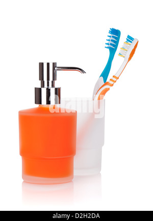 Two colorful toothbrushes and liquid soap. Isolated on white background Stock Photo