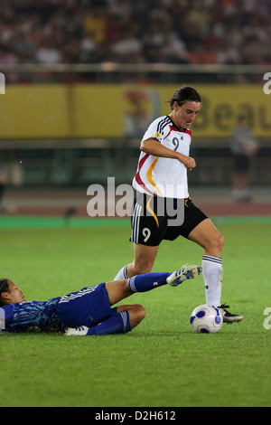 Azusa Iwashimizu of Japan (L) tries to tackle the ball from Birgit Prinz of Germany (R) during a FIFA Women's World Cup match. Stock Photo