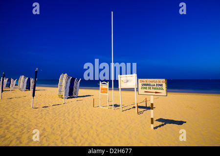 Albufeira, Portugal, stacked deck chairs on the beach Peneco Stock Photo