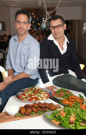 Restaurant owner Yotam Ottolenghi (left) with his head chef Sami Tamimi at the Upper Street restaurant in Islington, London, UK Stock Photo