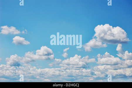 Blue sky with fluffy white clouds. Wide format. Photographic Image. Stock Photo