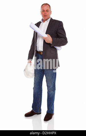 An architect or Surveyor wearing a jacket and jeans holding building plans and hard hat helmet, isolated on a white background. Stock Photo