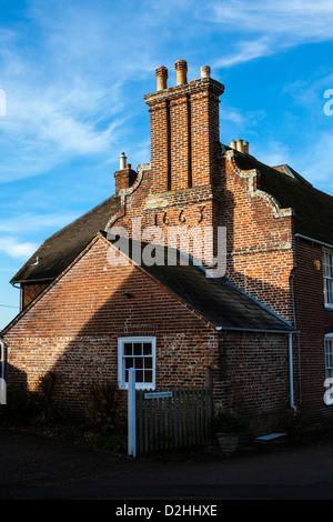 Historic red brick farmhouse with chimneys, dated 1663 in the pretty Kent village of Ickham, UK Stock Photo