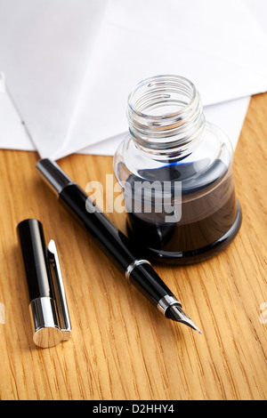 the fountain pen and inkwell on desk Stock Photo