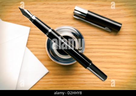 the fountain pen and inkwell on desk Stock Photo