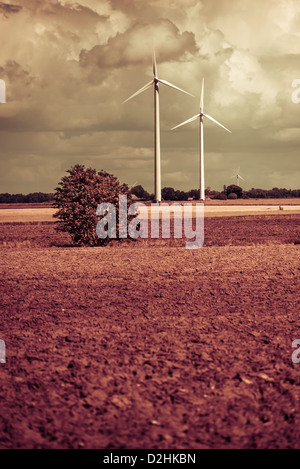 Modern windmills generating electricity in rural landscape Stock Photo