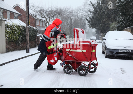 Postman delivers the mail in  a snowfall. Stock Photo