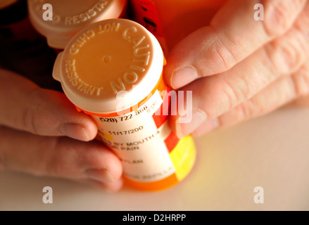 Bottles containing medications taken by a chronically ill senior patient. Stock Photo