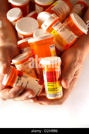 Bottles containing medications taken by a chronically ill senior patient. Stock Photo