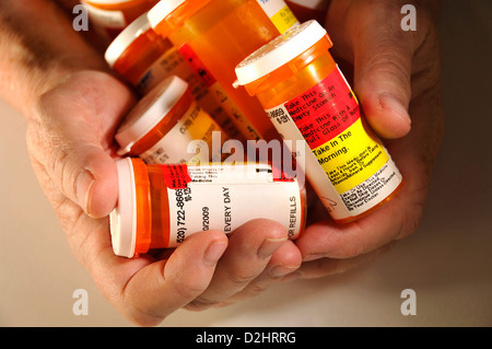 Bottles containing medications taken by a chronically ill senior patient. Stock Photo