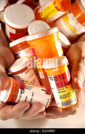 Bottles containing medications taken by a chronically ill senior patient. Stock Photo