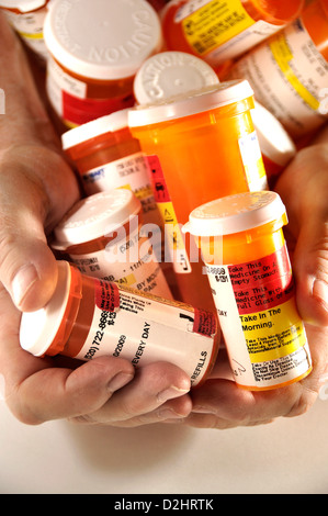 Bottles containing medications taken by a chronically ill senior patient. Stock Photo