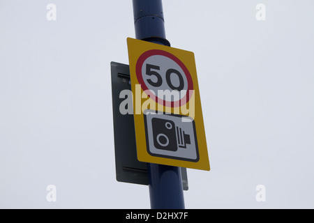Speed camera warning sign and 50mph speed limit notice on a British ...