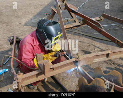 Country welder outdoor welding hard disk harrows Stock Photo