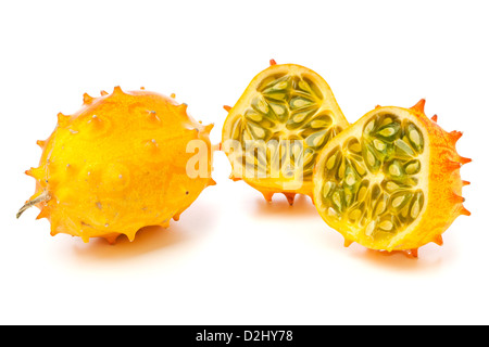 Whole and halved Kiwano fruits, also called African Horned melon or Horned Cucumber, isolated on white background Stock Photo
