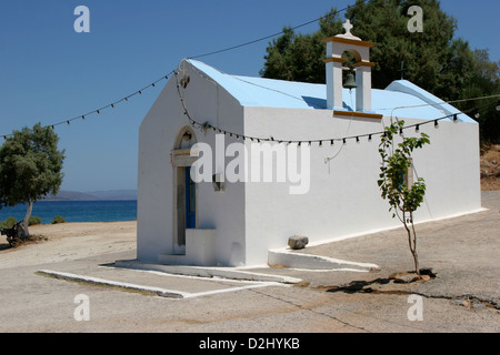 A small blue and white Greek Orthodox Chapel by the Mediterranean sea Stock Photo