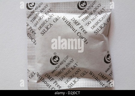 Sachet of silica gel on white background - desiccant that adsorbs and holds water vapor Stock Photo