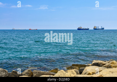 Cargo ships in the sea on horizon Stock Photo