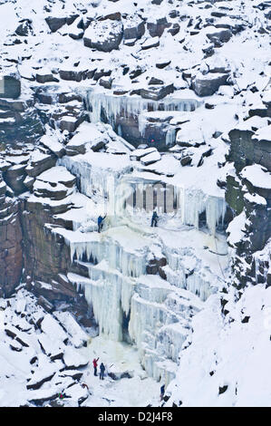 English Peak District, UK. 25th January 2013.  Ice climbers climbing a frozen waterfall ,Kinder Downfall on Kinder Scout, Derbyshire, Peak District National Park. Stock Photo