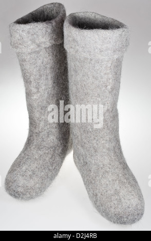 pair of knee-high felt boots on grey background Stock Photo