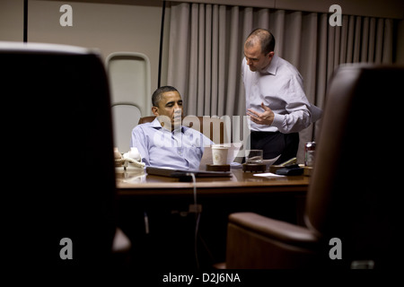 US President Barack Obama works on his address to the nation with Ben Rhodes, Deputy National Security Advisor for Strategic Communication, aboard Air Force One before landing May 1, 2012 in Afghanistan. Stock Photo
