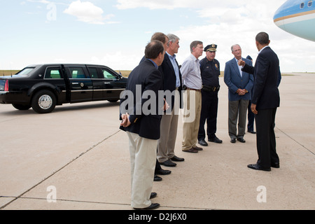 President Barack Obama talks with state and local officials upon his arrival at Buckley Air Force Base in Aurora, Colorado July 22, 2012. Pictured, from left, are: Rep. Ed Perlmutter, D-Colo.; Sen. Michael Bennet, D-Colo.; Sen. Mark Udall, D-Colo.; Colorado Gov. John Hickenlooper; Police Chief Dan Oates; and Aurora Mayor Steve Hogan. Stock Photo